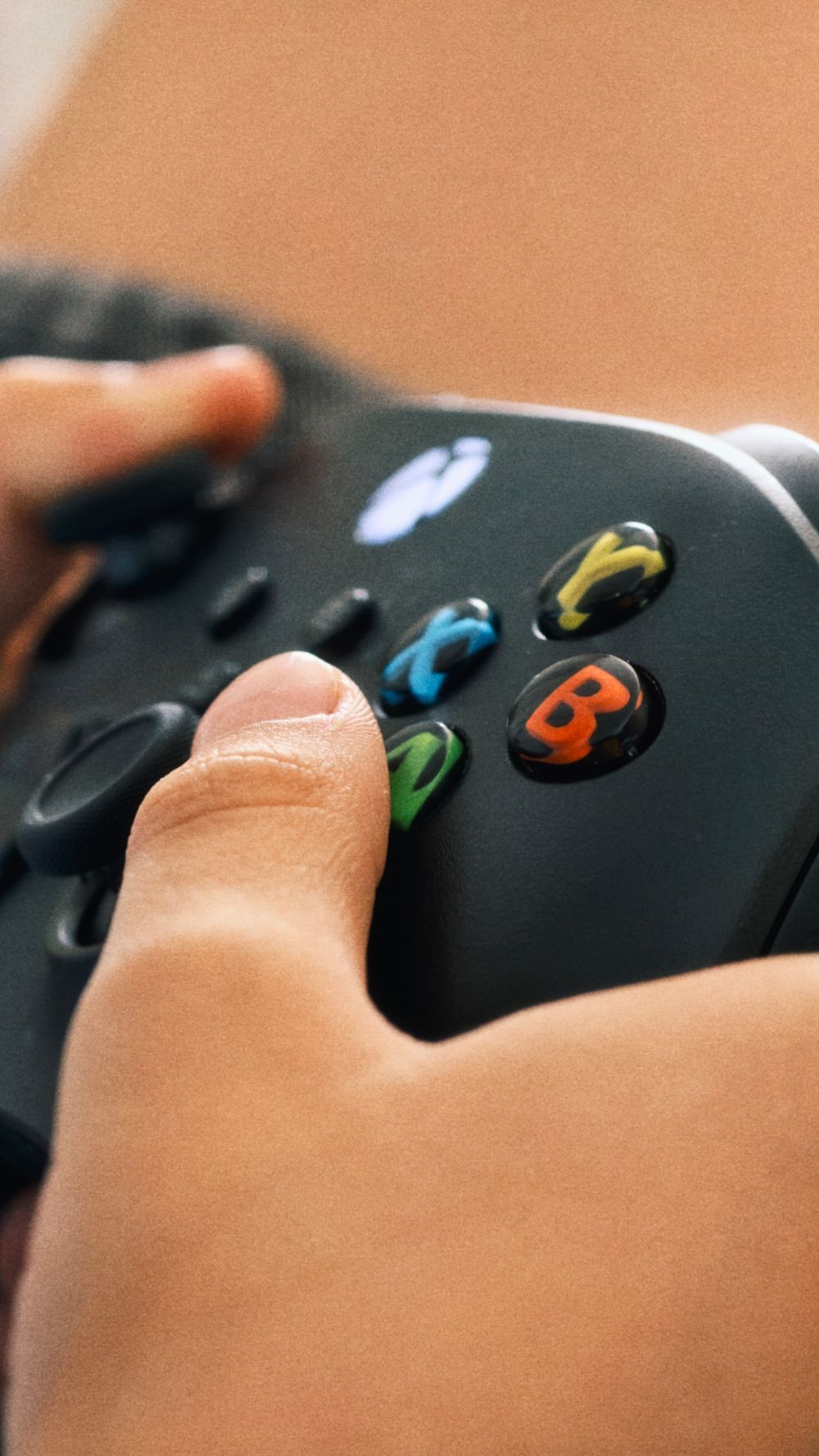 A child intensely focuses on a video game using a black controller.