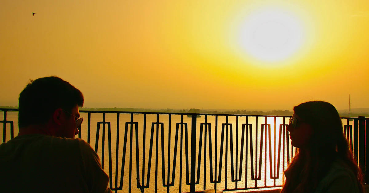 Couple watches the sunset over the water